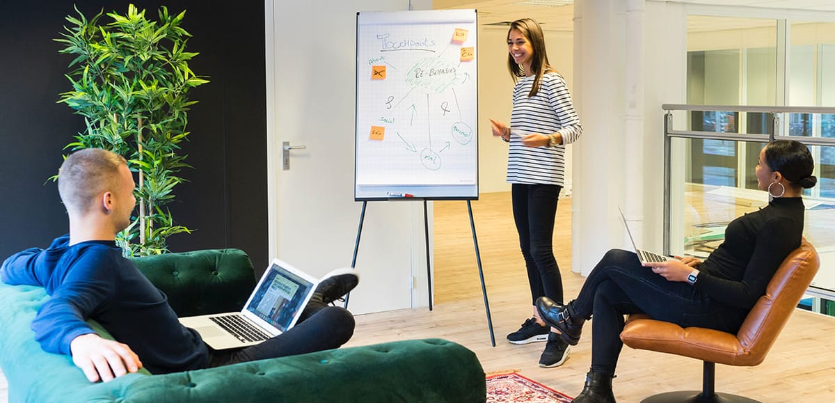 A strategy workshop in progress at a whiteboard in a bright office