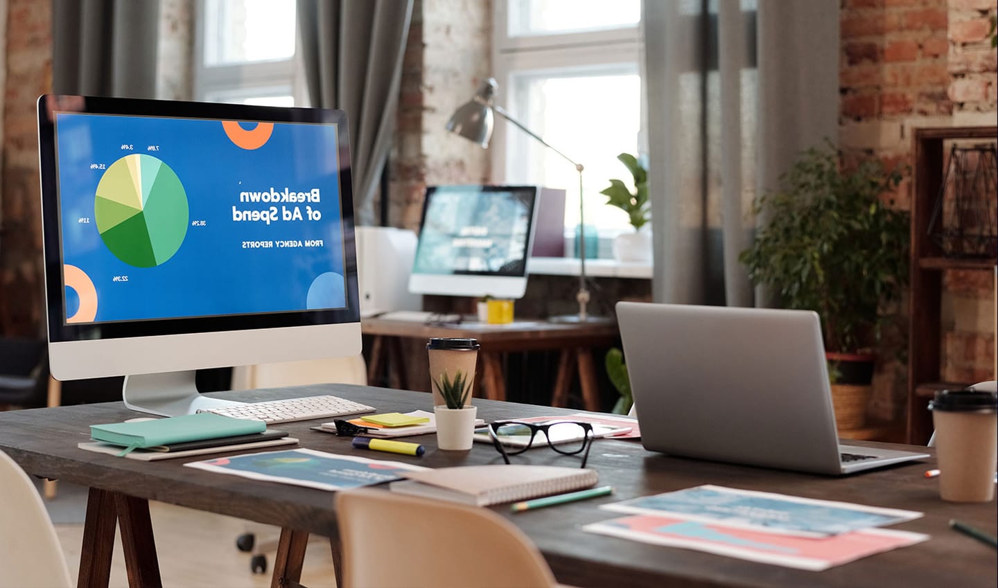 An eCommerce analytics dashboard open on a workspace desk