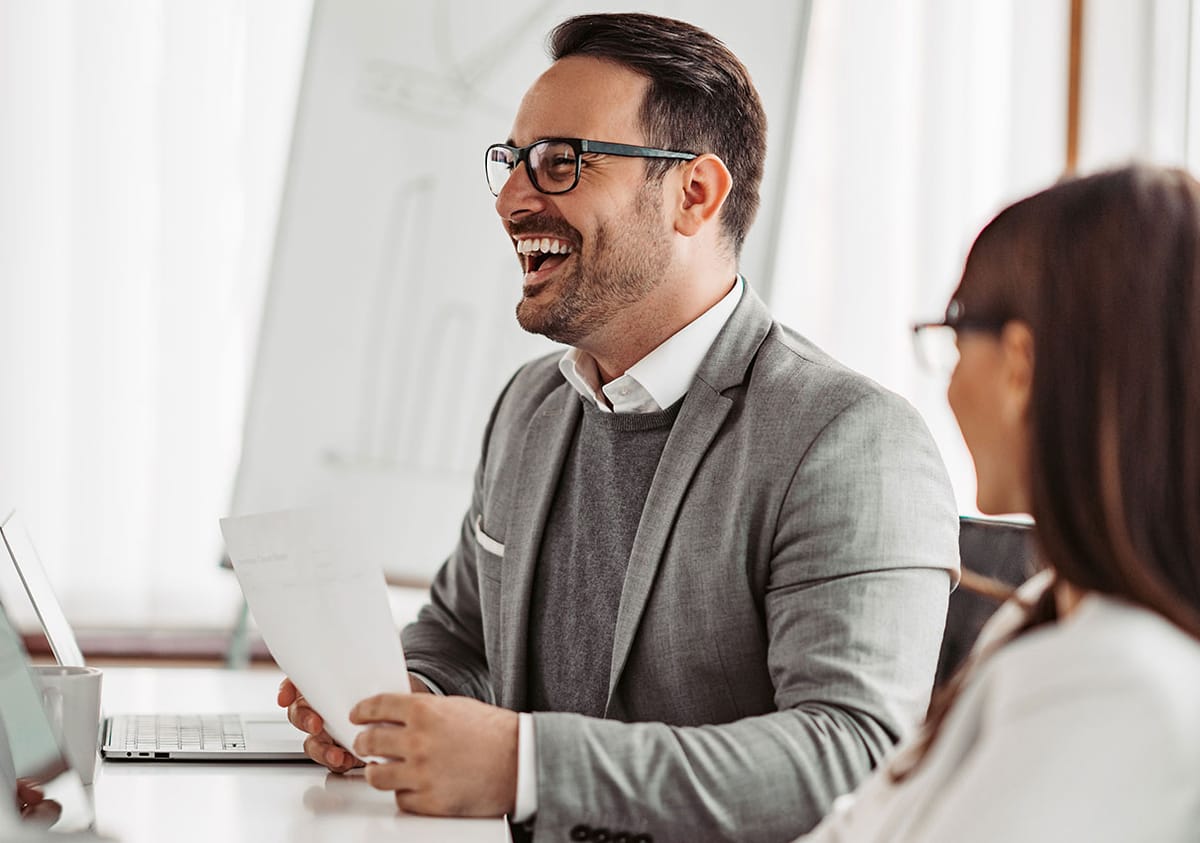 A business owner discussing engagement terms with a senior adviser